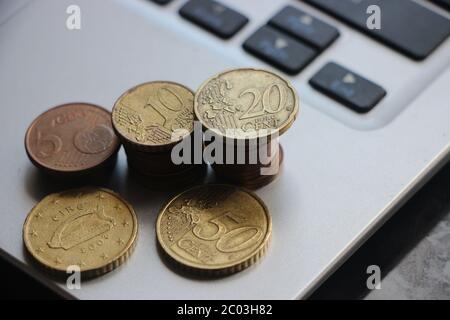 Euro currency coins put on computer keyboard. Small business startup financing concept Stock Photo