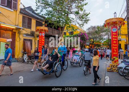 Rickshaws transporting tourists, Le Loi street, old town, Hoi An, Vietnam, Asia Stock Photo