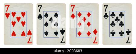 Four Vintage Playing Cards Isolated on White Background, Showing Seven from Each Suit - Hearts, Clubs, Spades and Diamonds Stock Photo