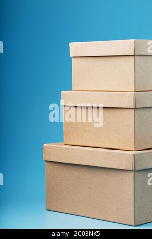 Postal cardboard boxes on a blue background close-up. Stock Photo