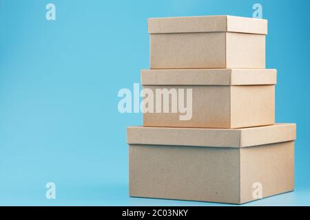 Postal cardboard boxes on a blue background close-up. Stock Photo