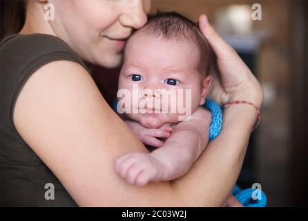 Baby boy in the arms of her mother Stock Photo