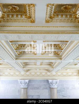 Gold plaster long ceiling with plaster moldings. Stock Photo