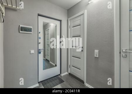 Empty residential house entrance with closed wooden doors tiny hallway Stock Photo