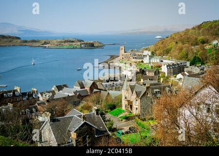 View of the McCaig's Tower on Battery Hill overlooking the town of Oban in Argyll and Bute, known as the seafood capital of Scotland. Stock Photo