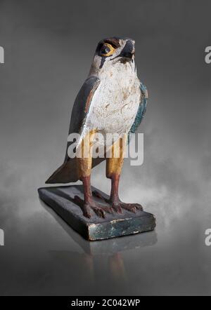 Ancient Egyptian wooden falcon bird, Late Period (722-322 BC). Egyptian Museum, Turin. Grey background.   Wooden tomb models were an Egyptian funerary Stock Photo