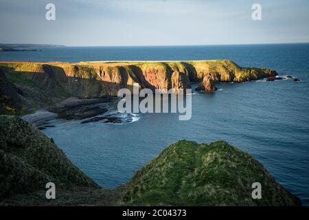 Dunnottar Castle is a ruined medieval fortress located upon a rocky headland on the north east coast of Scotland, near Stonehaven high cliffs Stock Photo