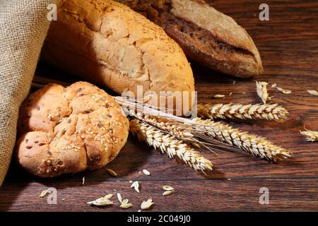 Bread of a house batch and cones on a wooden table