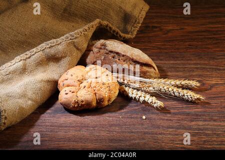 Bread of a house batch and cones on a wooden table