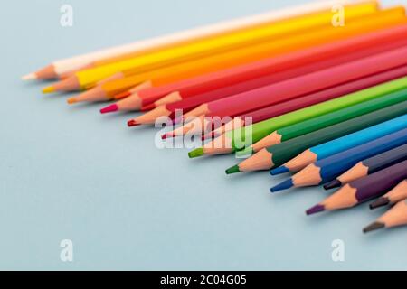 a selection of colourful sharpened pencils lined up on a table Stock Photo