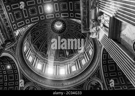 VATICAN CITY - MAY 07, 2019: Ray of light in the dome. Interior of the Saint Peters Basilica, Vatican in Rome, Italy. Stock Photo