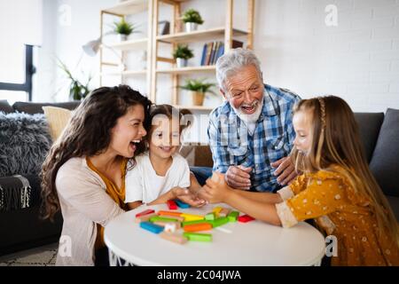 Happy family playing together and having fun at home Stock Photo