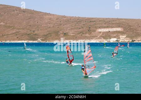 Young woman leading training run during preparations for PWA World Tour Windsurfing Competition in Alacati. Stock Photo