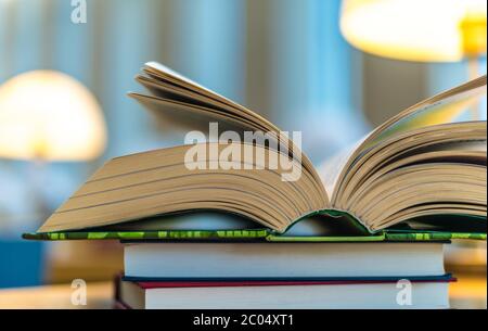 Open book lying on the table in the public library Stock Photo