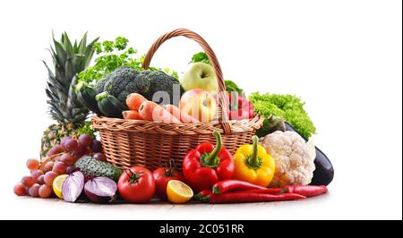 Assorted organic vegetables and fruits in wicker basket isolated on white background. Stock Photo