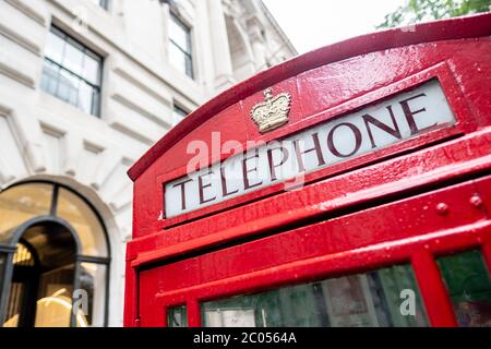 Red British Telephone box on urban street Stock Photo