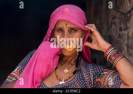 An Indian woman traditionally dressed at her home in a village in Rajasthan, India. Stock Photo
