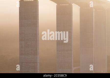 Large highway viaduct with foggy sunrise on autumn Stock Photo