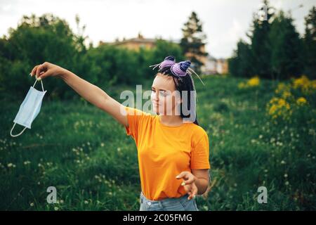 Download Young Beautiful Girl Unusual Bright Appearance Throwing Out A Medical Mask In A Yellow Shirt In The Open Air Stock Photo Alamy Yellowimages Mockups