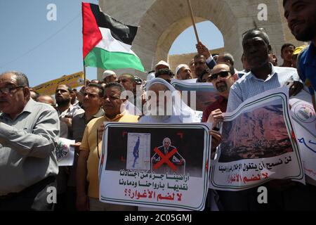 Rafah, Gaza. 11th June, 2020. Palestinians lift placards during a protest against Israel's plans to annex part of the occupied West Bank, at Rafah in the southern Gaza Stri, on Thursday, June 11, 2020. Israel has signaled it intends to annex West Bank settlements and the Jordan Valley, with initial steps slated to begin from July 1. Photo by Ismael Mohamad/UPI Credit: UPI/Alamy Live News Stock Photo