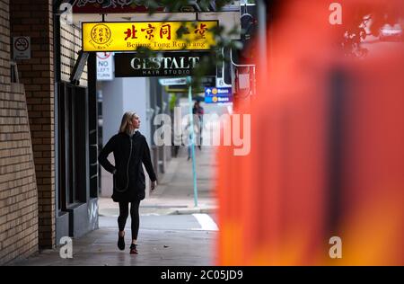 Sydney, Australia. 10th June, 2020. A woman walks past a Tong Ren Tang store in Sydney, Australia, on June 10, 2020. Chinese investment in Australia fell by 58 percent in 2019 compared to in 2018, despite also recording a jump in bilateral trade, according to a new report by the University of Sydney and financial services giant KPMG. Credit: Bai Xuefei/Xinhua/Alamy Live News Stock Photo