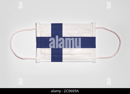 Symbol picture Corona crisis, mouth guard, respirator, mouth and nose protection with flag of Finland, white background Stock Photo