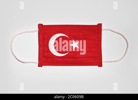 Symbol picture Corona crisis, mouth protection, breathing mask, mouth nose protection with flag of Turkey, white background Stock Photo