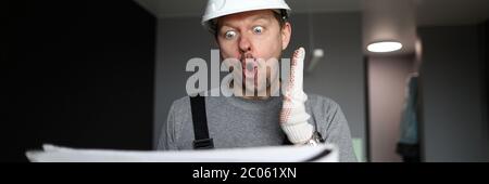 Shocked handyman or engineer looking at scheme Stock Photo