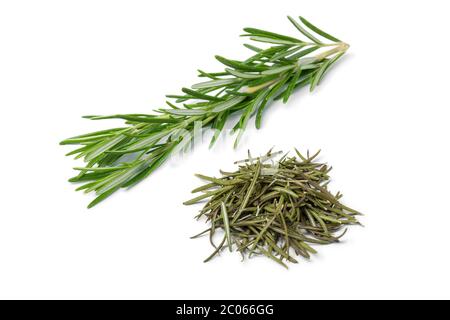 Heap of dried rosemary and fresh rosemary twig isolated on white background Stock Photo