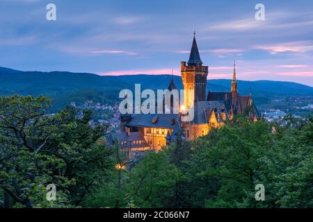 View of the illuminated Wernigerode Castle in the twilight, Wernigerode, Harz, Saxony-Anhalt, Germany Stock Photo