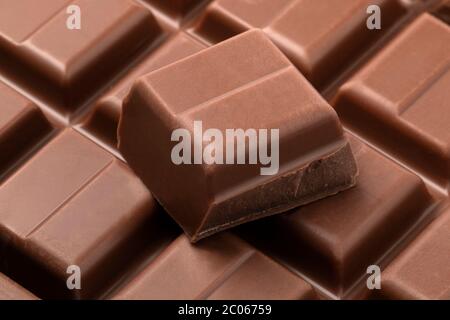 Bar of milk chocolate and pieces close up full frame Stock Photo