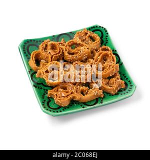 Dish with Moroccan festive homemade chebakia cookies isolated on white background Stock Photo