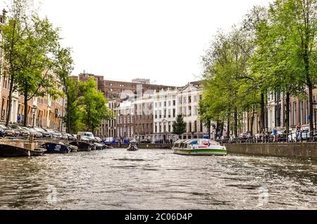 AMSTERDAM, HOLLAND – AUG. 31, 2019: Beautiful view of Amsterdam canals with bridge and typical dutch houses. Stock Photo