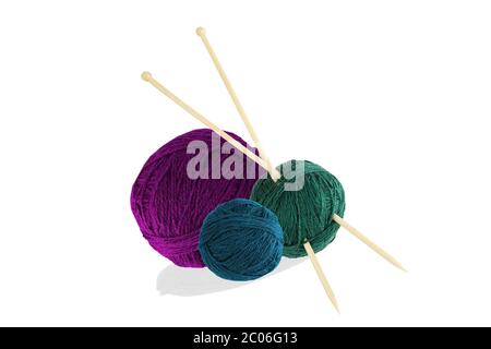 Three balls of wool with knitting needles isolated on white background Stock Photo