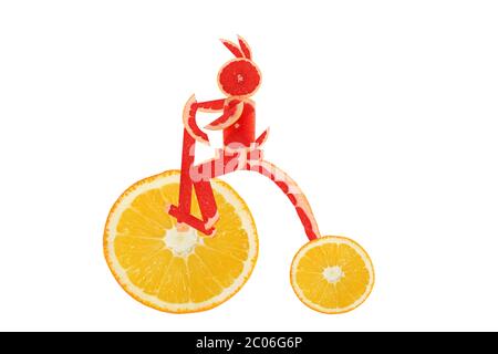 Healthy eating. Funny vintage bike  made of the orange  slices with  little rabbit Stock Photo