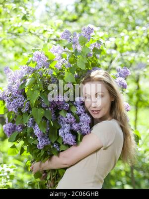 woman in park with a big bouquet of a lilac Stock Photo