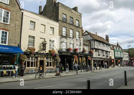 Cambridge, UK - September 19, 2011:   Shoppers walking by historic pubs of Bridge Street on September 19 2011. The street is famous for its drinking e