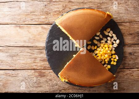 Apam Balik is a sweet Malaysian peanut pancake turnover stuffed with a sugary, buttery peanut filling close-up on the table. Horizontal top view from Stock Photo