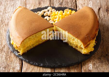 Malaysian pancake Apam Balik stuffed with sweet corn, peanuts, butter and sugar close-up on the table. horizontal Stock Photo