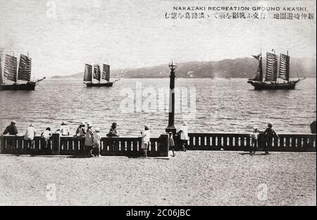 [ 1920s Japan - Japanese Sailing Vessels ] — Children watch sailing vessels at the Nakazaki Recreation Ground in Akashi, Hyogo Prefecture.   In the back Awajishima island is visible.  20th century vintage postcard. Stock Photo