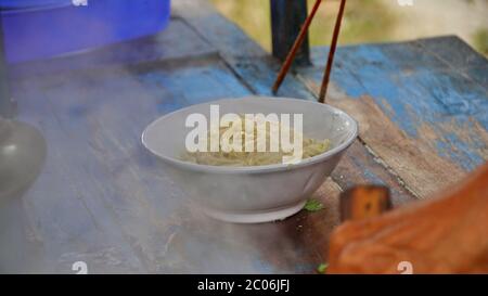 street chicken noodle sellers prepare food menus  on the cart. Not focus, noise and Blurry selective focus image Stock Photo