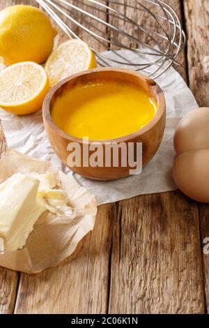 Traditional hollandaise sauce with ingredients eggs, lemon, butter close-up on the table. vertical Stock Photo