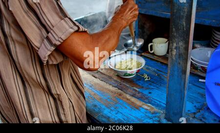 street chicken noodle sellers prepare food menus  on the cart. Not focus, noise and Blurry selective focus image Stock Photo