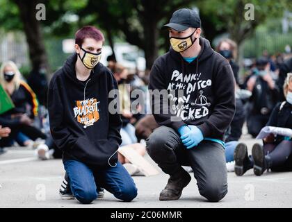 Newport, Wales, UK. 11th June, 2020. Protesters kneel at the Black Lives Matter march in Newport. Hundreds of people joined the protest following the death of George Floyd, a 46 year old, African-American man, who died during an arrest by the Minneapolis police for allegedly using a counterfeit bill. His death has sparked huge protests across the world against racial discrimination. Credit: Tracey Paddison/Alamy Live News Stock Photo