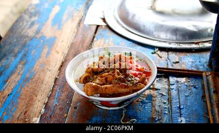 street chicken noodle sellers prepare food menus  on the cart. Not focus, noise and Blurry selective focus image Stock Photo