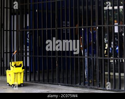 Valencia, Carabobo, Venezuela. 11th June, 2020. June 11, 2020.A man works behind closed doors in cleaning tasks for a shopping center, during the days of quarantine decreed by the government of Nicolas Maduro to face the covid pandemic.in the city of Valencia, Carabobo state. Photo: Juan Carlos Hernandez Credit: Juan Carlos Hernandez/ZUMA Wire/Ģ����ý Live News Stock Photo