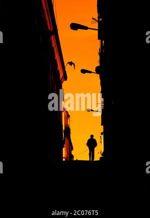 Old man walking his dog in an alley i n Lisbon Stock Photo