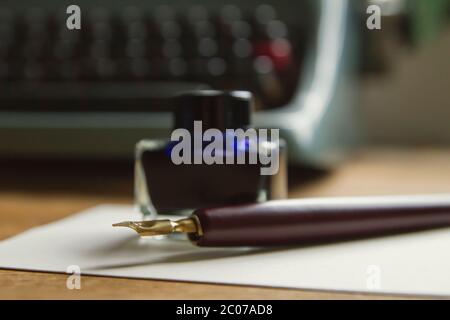 Blue ink and fountain pen on a desk Stock Photo