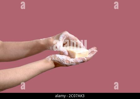 Hands wash hands with soap on a pink backgrapund Stock Photo