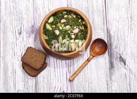 Okroshka with kvass in a wooden bowl and rye bread Stock Photo